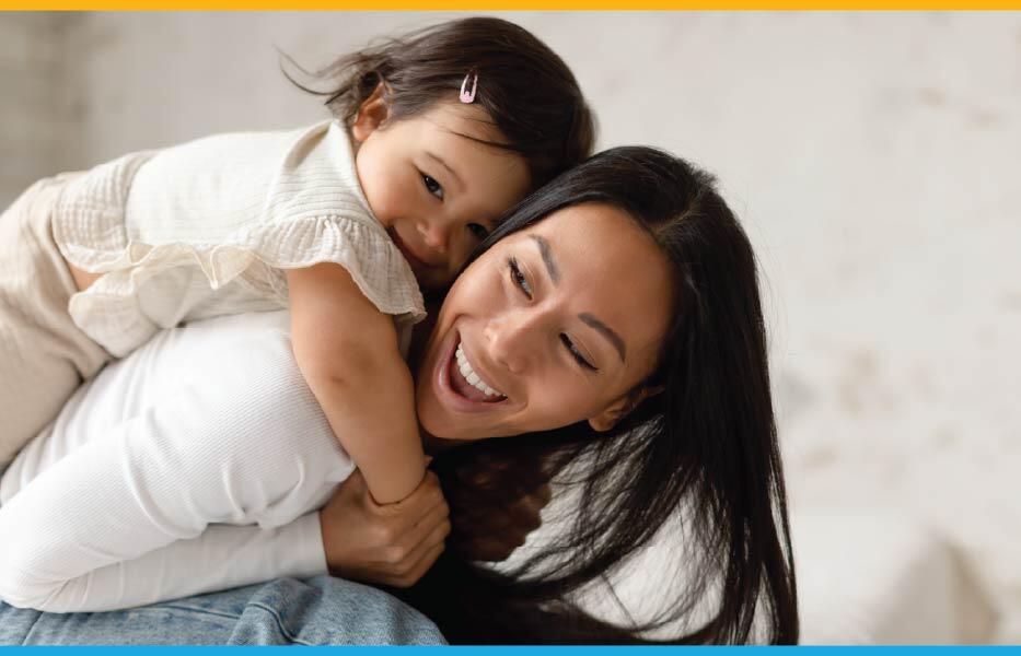 Asian mother with her daughter on her back, both laughing